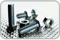 Picture of stainless steel bolts and hex nuts on metal surface